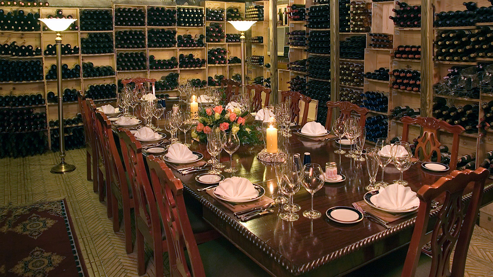 A table set in a private dining space at Graycliff, set amid shelves of stacked wine bottles